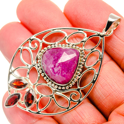 Sterling silver ruby pendant with oval pink gemstone, ornate openwork frame, top bail