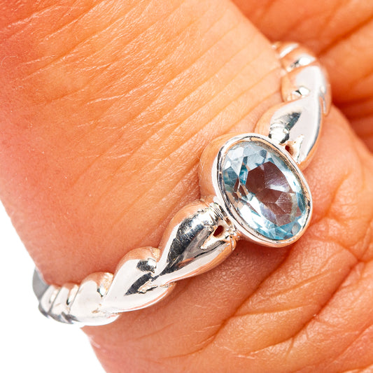 Sterling silver dainty ring with oval blue topaz gemstone and sculpted prongs