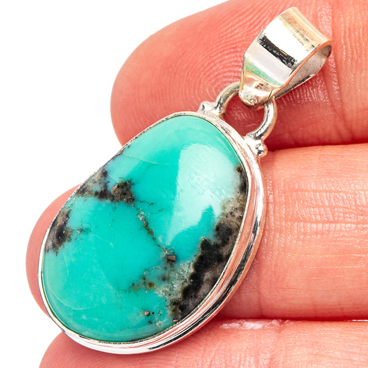Oval turquoise stone pendant in .925 sterling silver bezel with bail, detailed close-up.