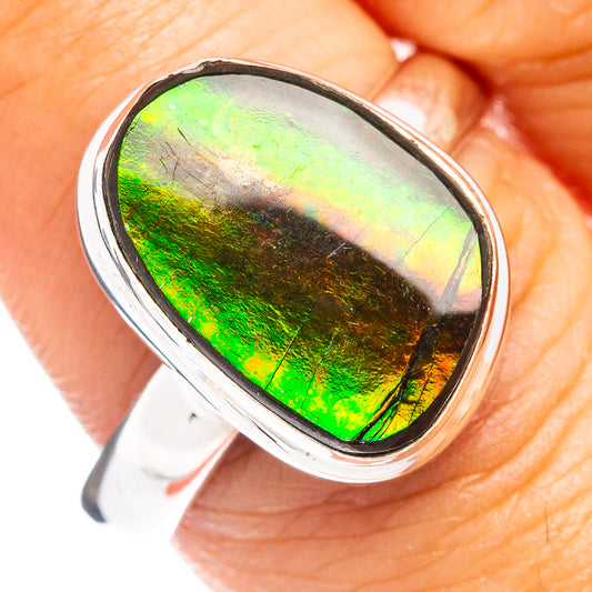 Oval ammolite stone ring with bright green iridescence in sterling silver bezel