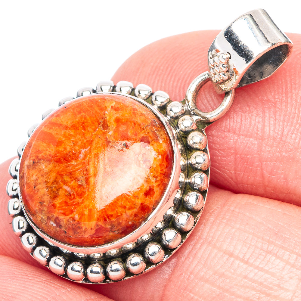 Orange coral cabochon silver pendant with oval bezel and beaded edge, bail clasp