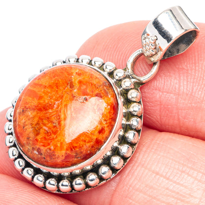 Orange coral cabochon silver pendant with oval bezel and beaded edge, bail clasp