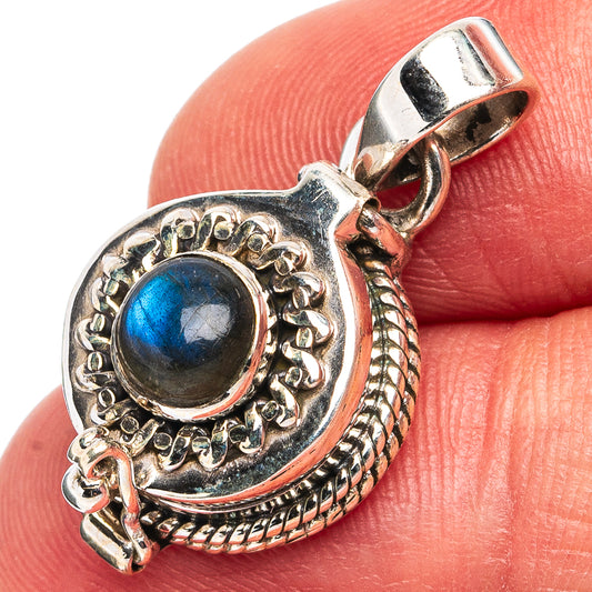 Sterling silver labradorite pendant close-up, blue cabochon in detailed border with bail