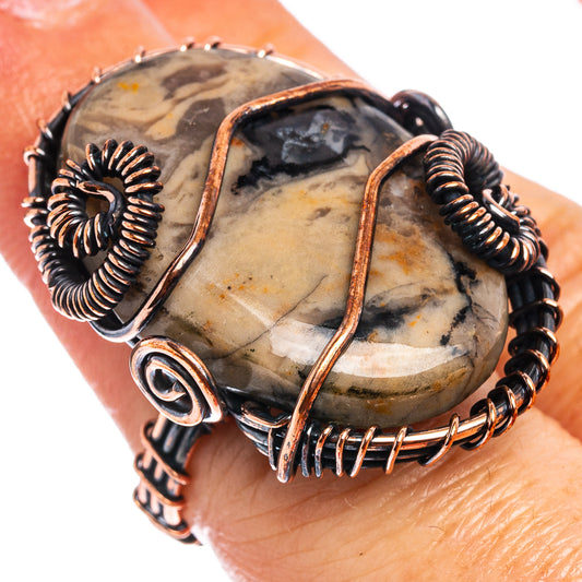Oxidized copper wire-wrap ring with oval fossil stone and spiral wire details