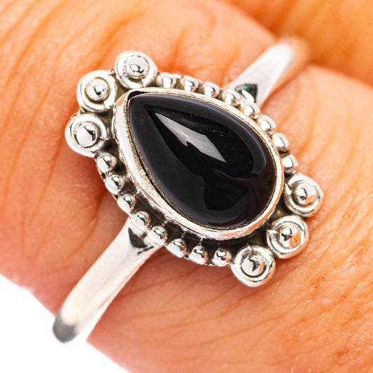 Sterling silver ring with oval black onyx and ornate beaded setting