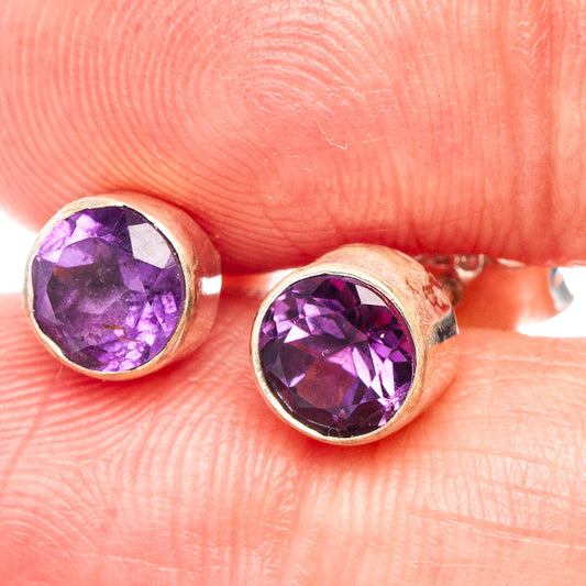 Amethyst stud earrings in .925 sterling silver with round faceted purple gemstones