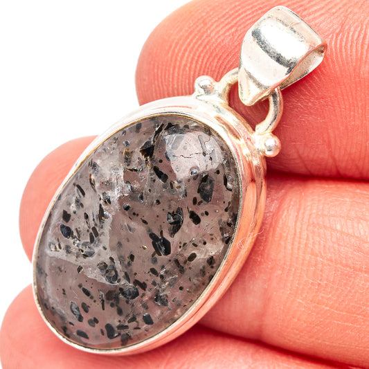 Oval hematite-in-quartz pendant with silver bezel and loop bail