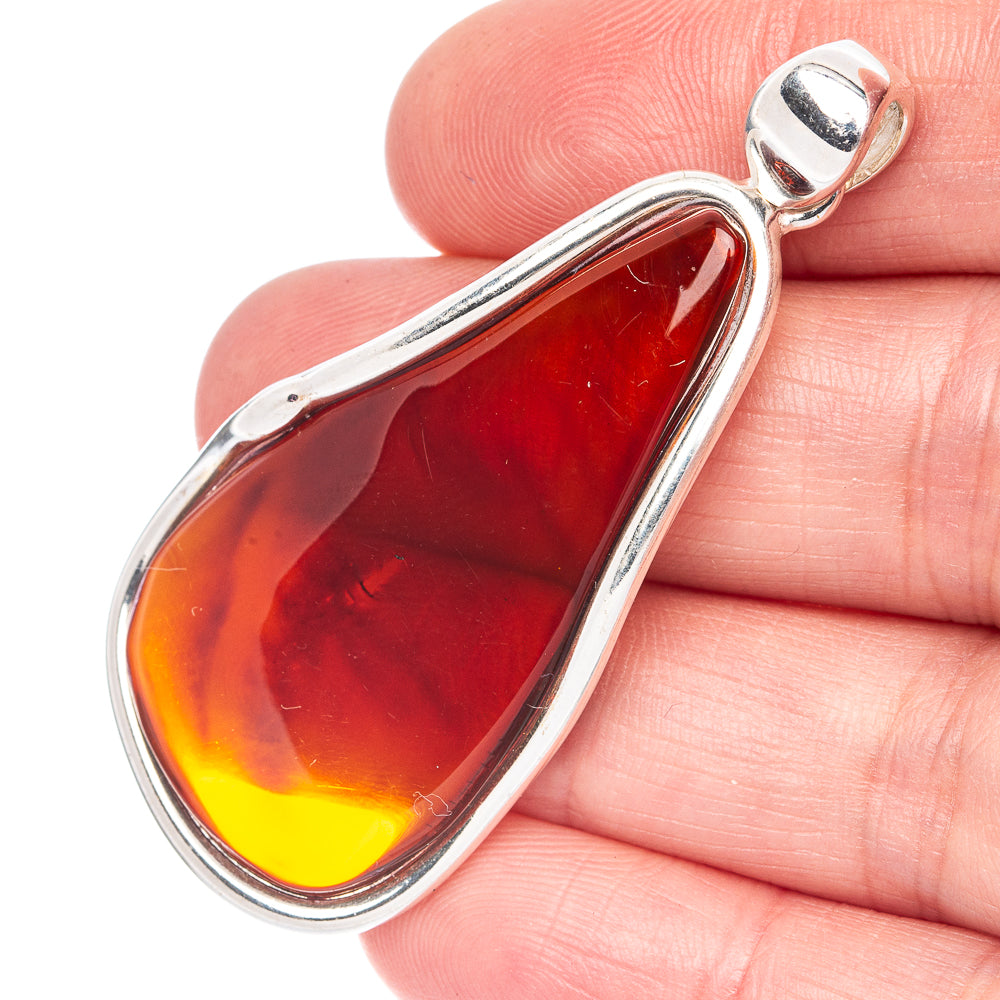 Silver teardrop amber pendant with translucent yellow-red stone in polished bezel