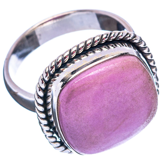 Purple cabochon gemstone ring with braided silver band and bezel, angled side view
