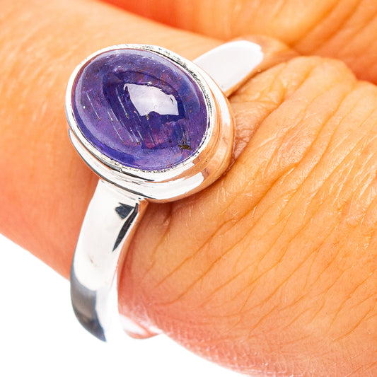 Sterling silver ring with oval purple gemstone cabochon in polished bezel setting