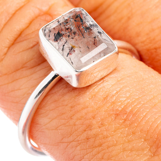 Sterling silver cacoxenite ring with square bezel-set stone on hand