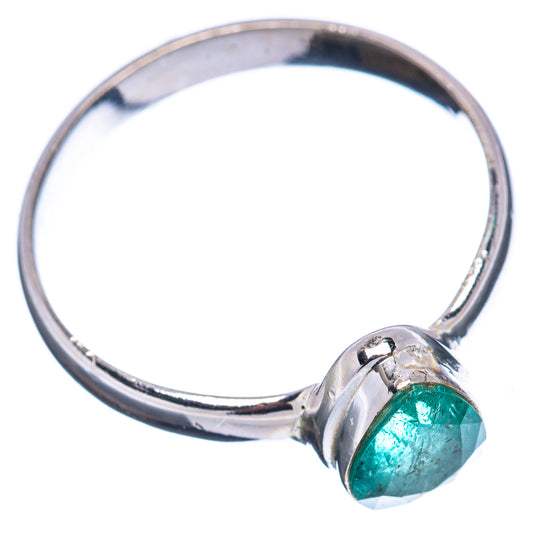Sterling silver band ring with small oval green emerald, side view
