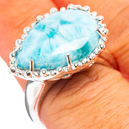 Sterling silver oval larimar ring with raised bezel and beaded edge, side view