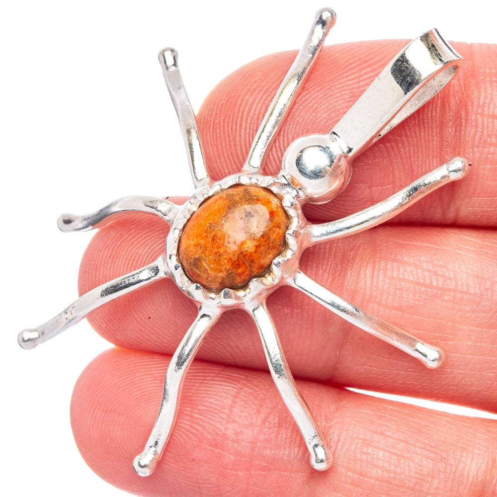 925 sterling silver spider pendant with orange coral cabochon and dangling legs