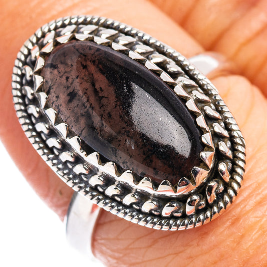 Sterling silver ring with dark oval quartz cabochon and engraved rope-style border