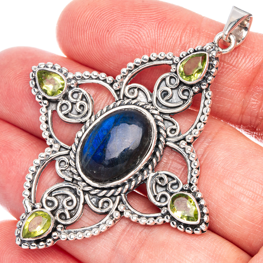 Sterling silver filigree pendant with blue oval stone and green teardrop accents