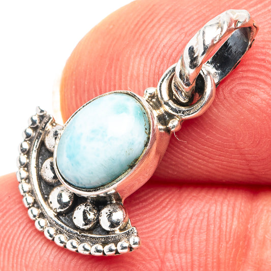 Oval light-blue gemstone pendant in .925 sterling silver with ornate openwork bezel