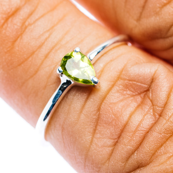 Stackable .925 sterling silver ring with oval green peridot and open bar band details