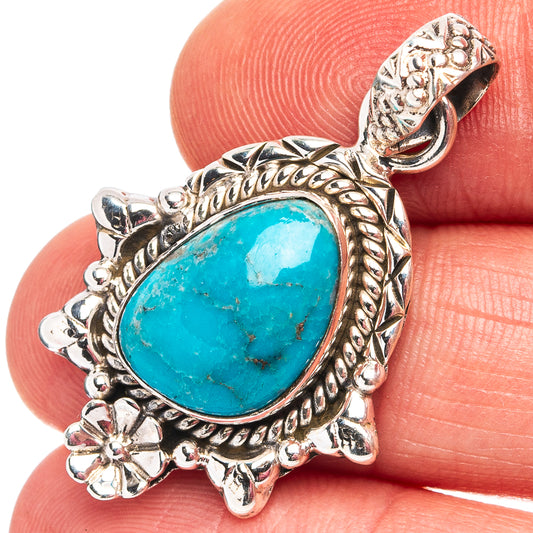 Turquoise teardrop pendant in .925 sterling silver with detailed floral bezel