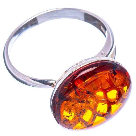 Open band sterling silver ring with round orange amber cabochon