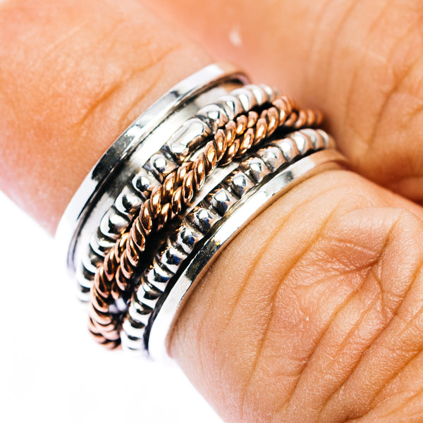 Sterling silver spinner ring with copper braided center inlay, side view