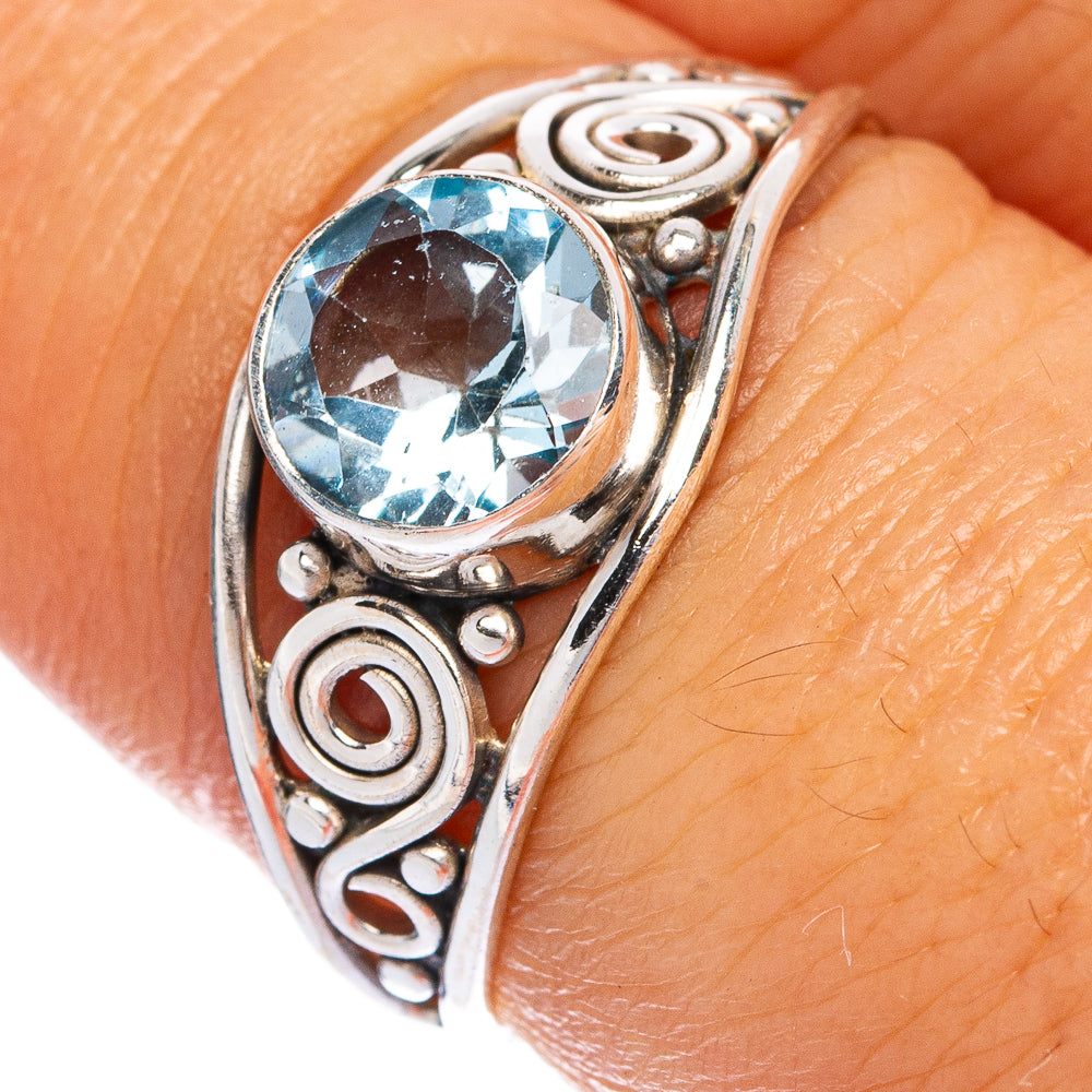Sterling silver dainty ring with round blue topaz and swirl cutout setting
