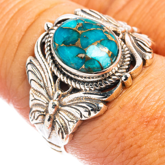 Turquoise butterfly ring with oval stone in silver setting, ornate leaf details