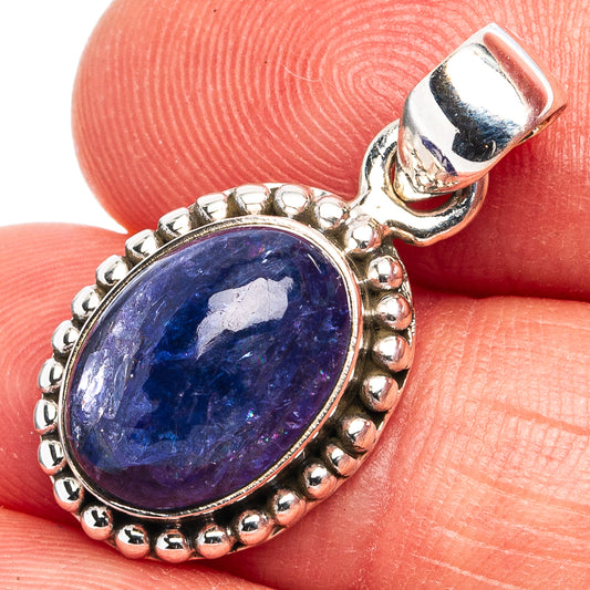 Oval blue tanzanite pendant in .925 sterling silver bezel with bead border and open bail.