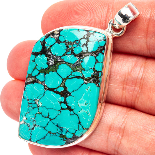 Turquoise stone pendant in oval teardrop shape, .925 sterling silver frame and bail.
