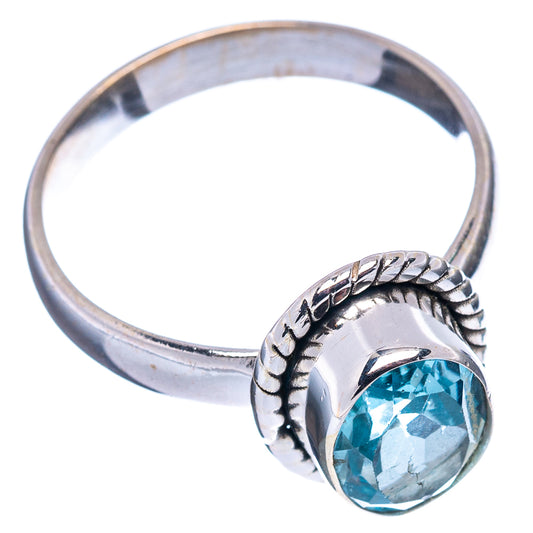 Sterling silver blue topaz ring with raised oval stone on carved shank, side view