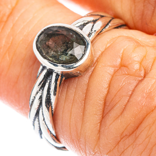 Sterling silver ring with oval faceted aquamarine and twisted band, close-up