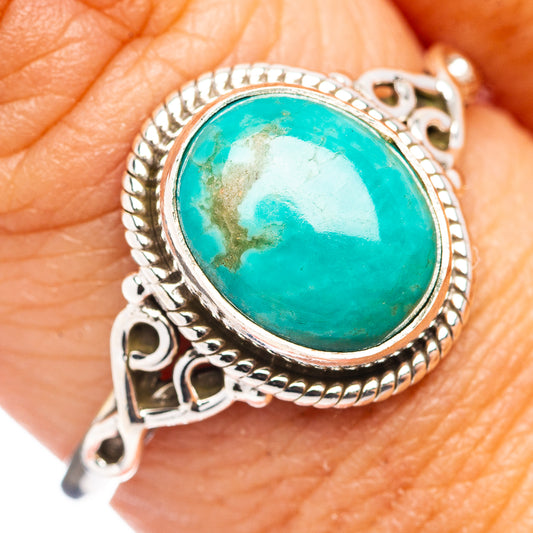 Oval turquoise cabochon sterling silver ring with rope bezel and decorative side cutouts