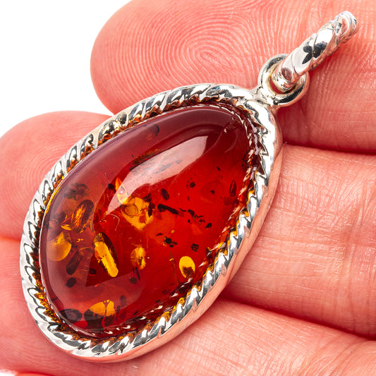 Oval Baltic Amber pendant with .925 sterling silver bezel, red-orange amber stone