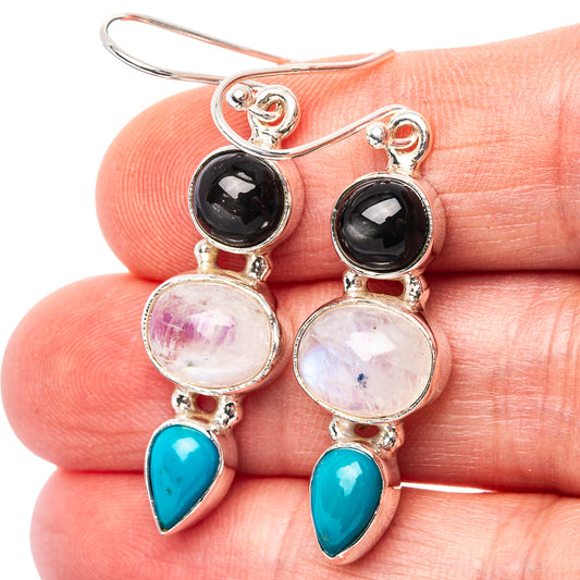Sterling silver drop earrings with moonstone-like pink discs, black accents, turquoise teardrops
