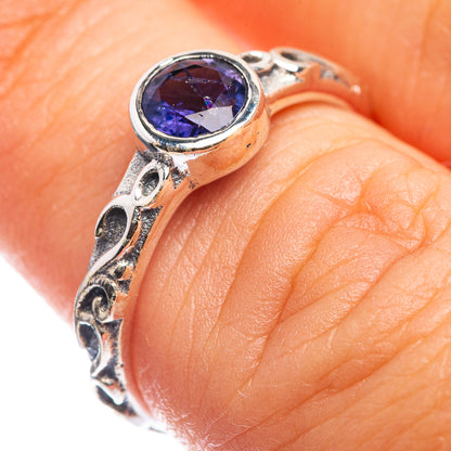 Dainty sterling silver ring with blue oval tanzanite-style gemstone and ornate band
