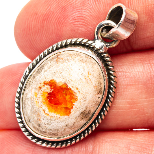 Oval fire opal pendant in round beaded sterling silver bezel with hinged bail