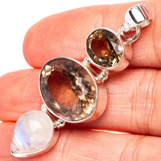 Sterling silver pendant with two faceted amber-brown stones and a teardrop moonstone charm