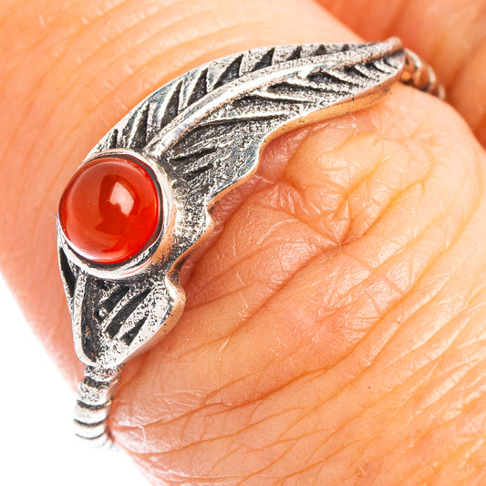 Feather-style sterling silver ring with red oval cabochon on top