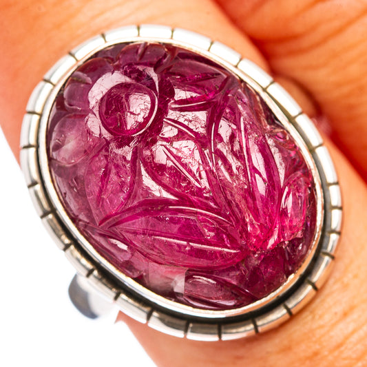 Carved ruby cabochon ring in oval bezel, deep pink-red gemstone with silver detail