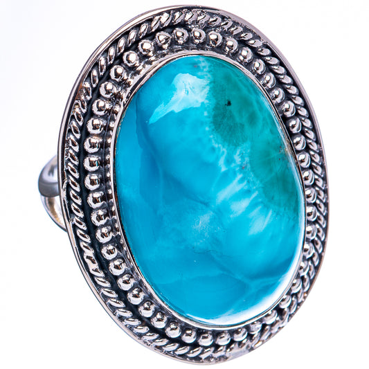 Oval Larimar ring in .925 sterling silver with decorative raised rim and turquoise stone