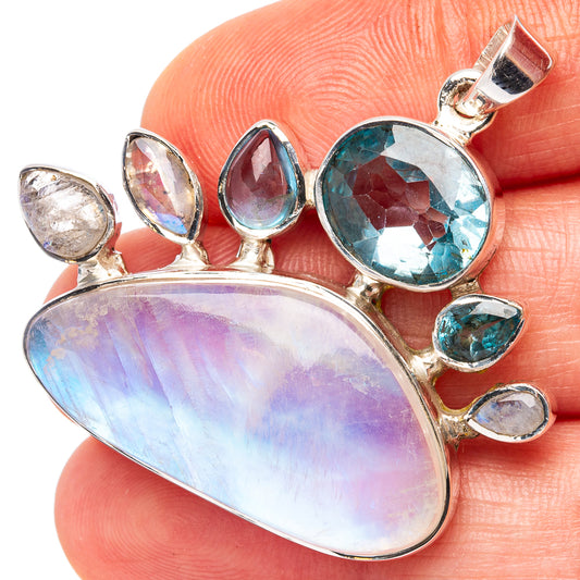 Sterling silver pendant with oval rainbow moonstone, blue topaz accents, bail loop