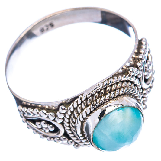 Sterling silver ring with oval turquoise cabochon and ornate side filigree