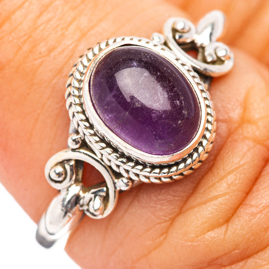 Sterling silver amethyst ring with oval purple stone and ornate rope bezel