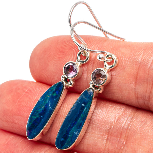 Sterling silver dangle earrings with blue oval opal drops and purple stone accents.