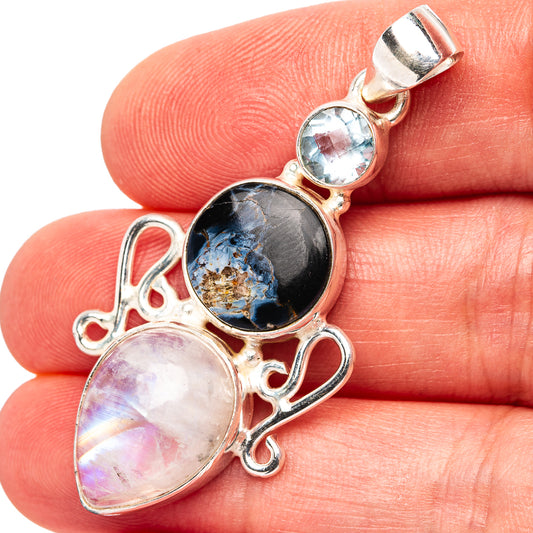 Sterling silver pendant with blue topaz, dark pietersite round, and moonstone oval