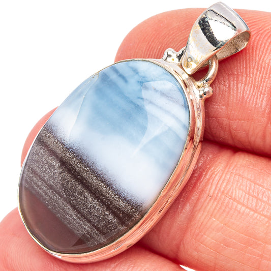 Sterling silver oval opal pendant with blue, white, and brown stone set in bezel