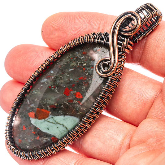 Oxidized copper wire-wrap teardrop pendant, dark stone with red speckles, round bail