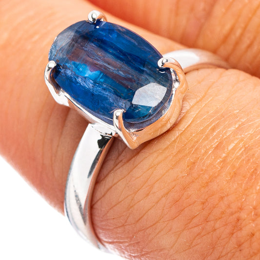 Sterling silver kyanite ring with oval blue gemstone bezel setting on band.