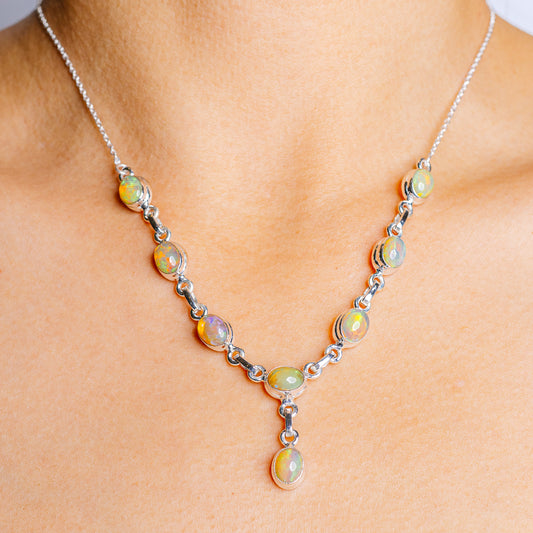 Ethiopian opal tennis-style necklace in .925 sterling silver with round opal drop
