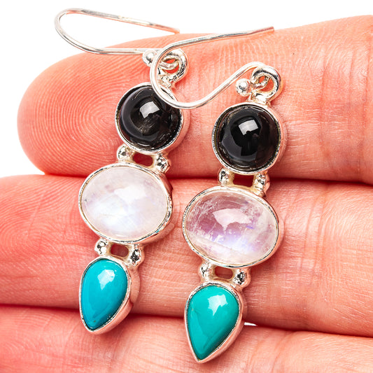 Sterling silver drop earrings with round moonstone, black stones, and turquoise teardrops